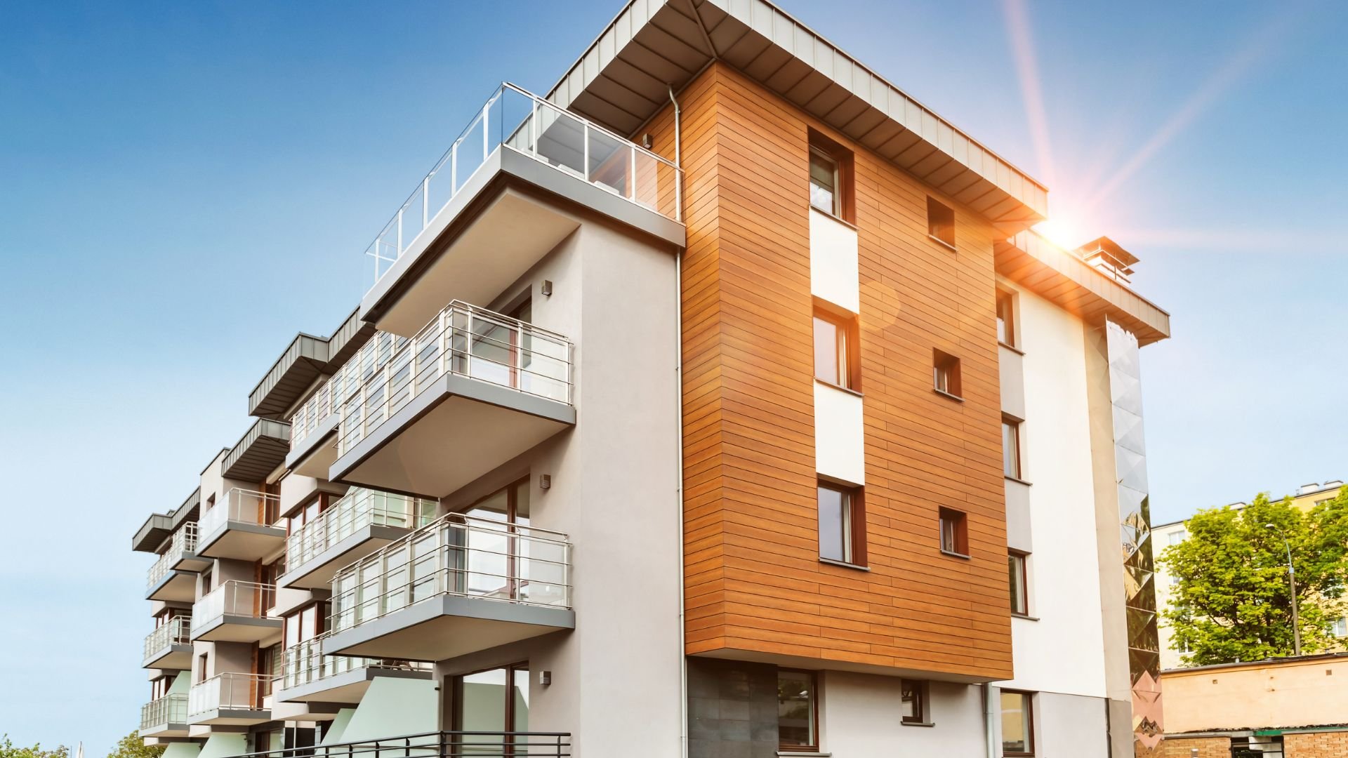 Modern apartment building with wood paneling and glass balconies